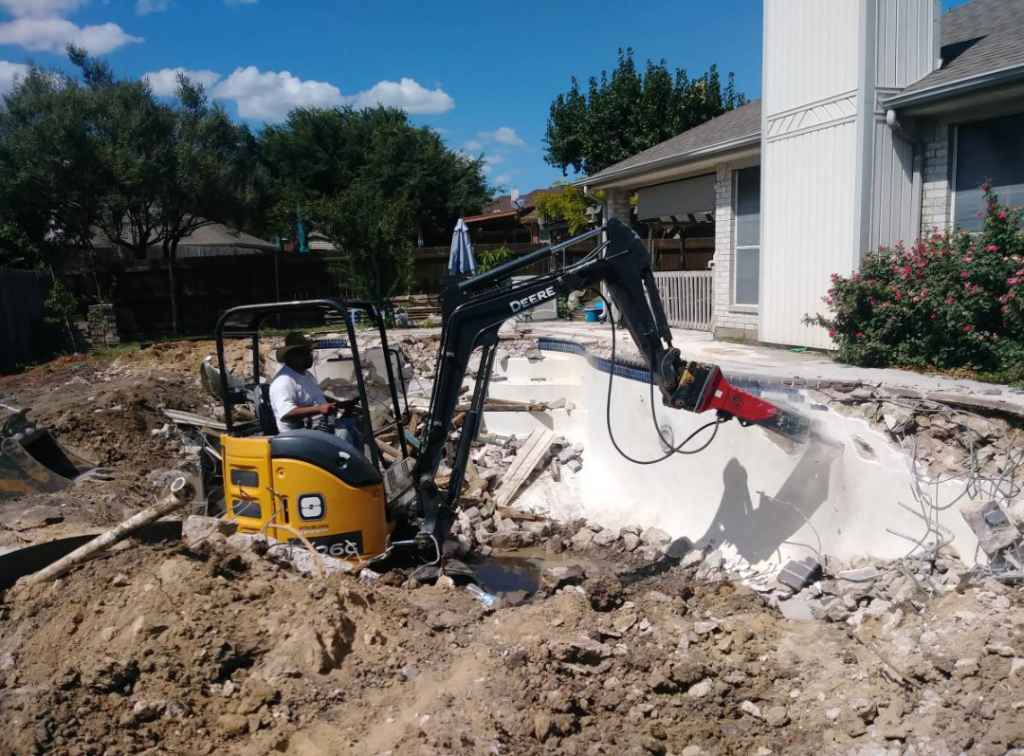 construction crew demolishing an old pool