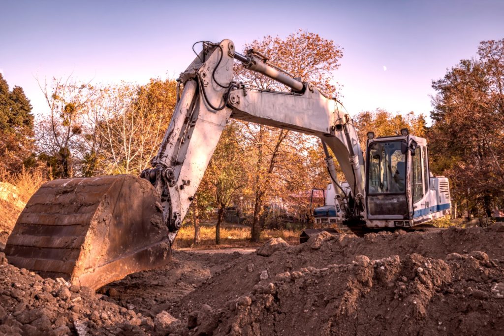 Big excavator with shovel at construction site.