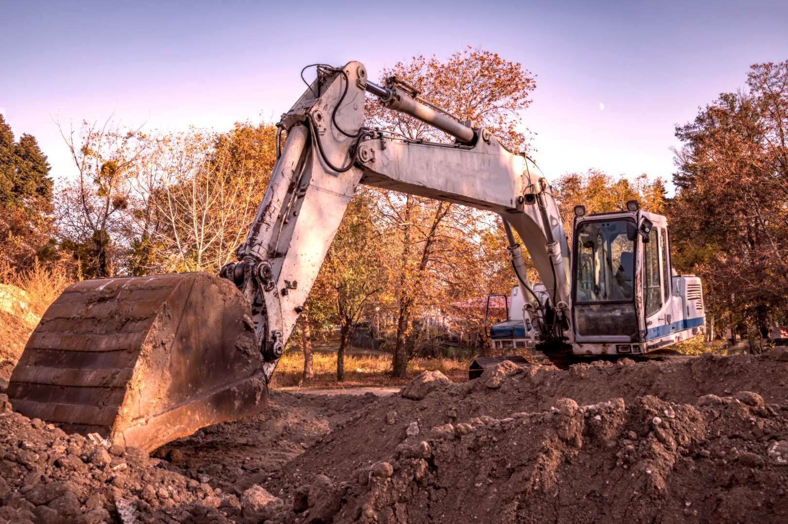 Big excavator with shovel at construction site.
